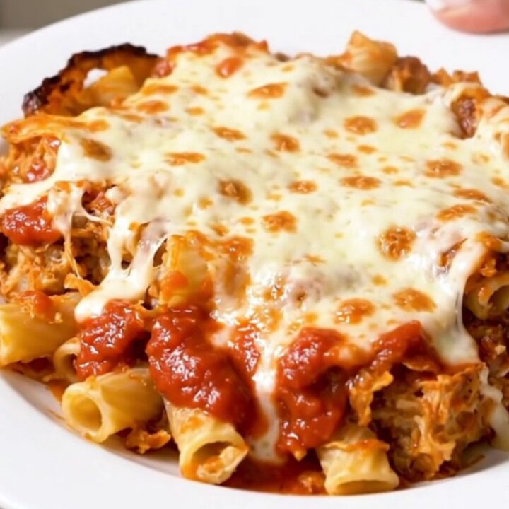A steaming bowl of baked ziti with melted mozzarella cheese and savory Italian sausage crumbles.