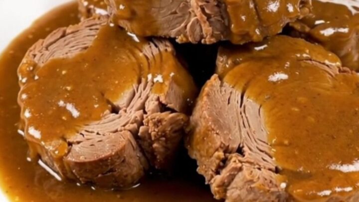 A succulent, slow-cooked pork roast topped with caramelized onions and a glossy, rich brown sugar Dijon sauce.