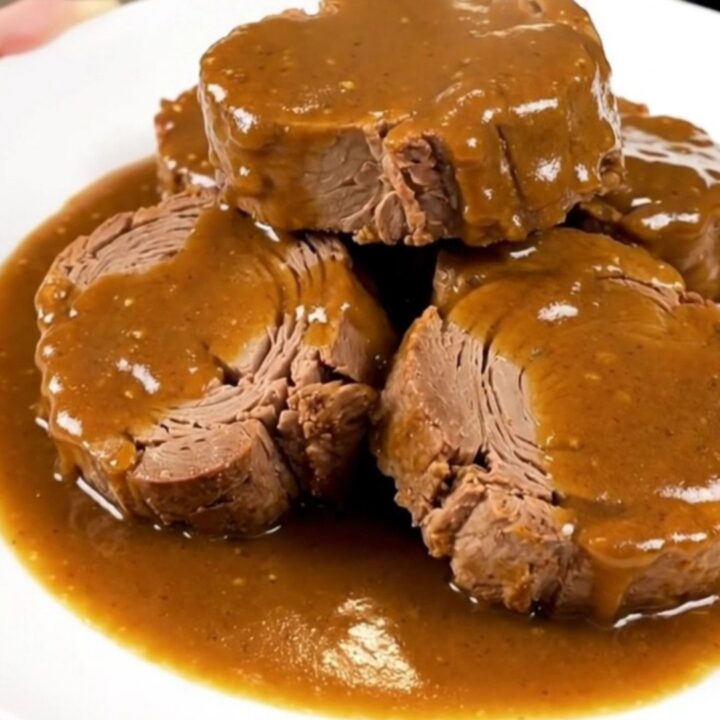 A succulent, slow-cooked pork roast topped with caramelized onions and a glossy, rich brown sugar Dijon sauce.