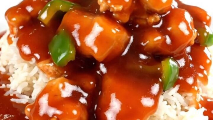 Slow cooker sweet and sour chicken with vibrant bell peppers and pineapple chunks.