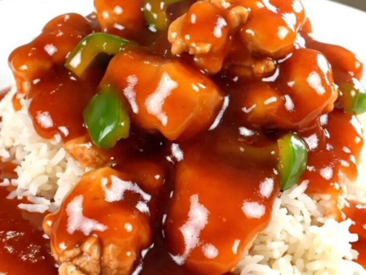 Slow cooker sweet and sour chicken with vibrant bell peppers and pineapple chunks.