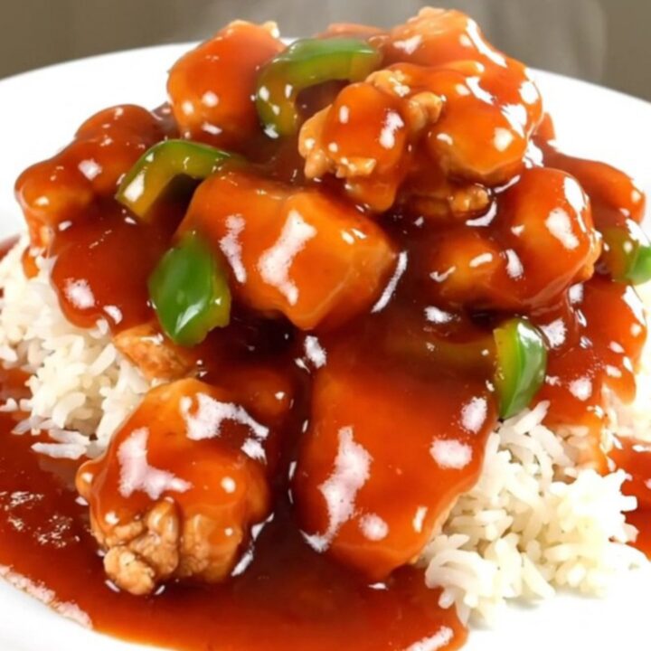 Slow cooker sweet and sour chicken with vibrant bell peppers and pineapple chunks.