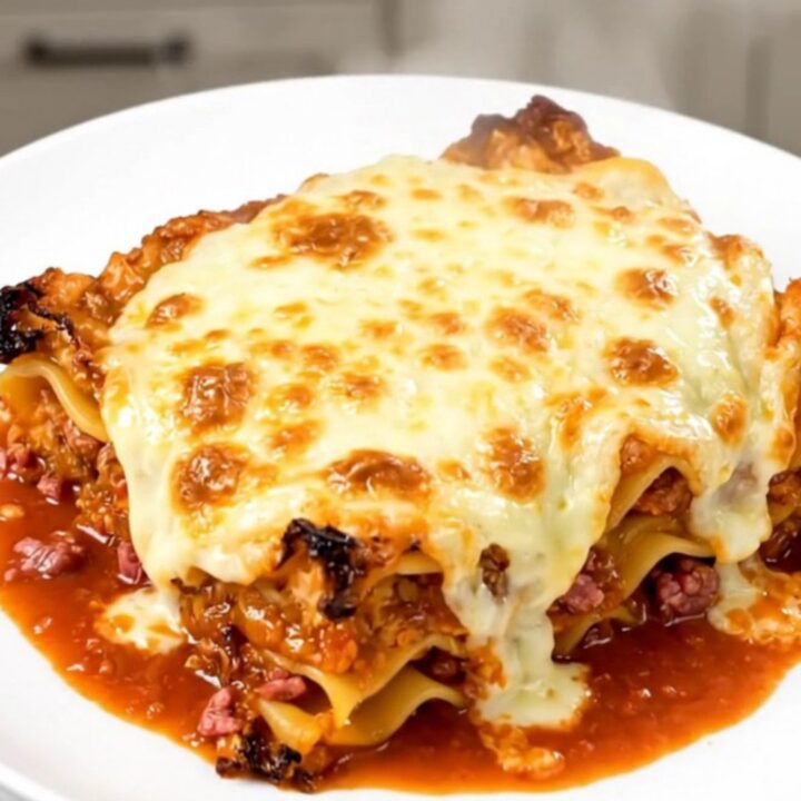 A steaming, hearty meat lasagna in a slow cooker with rich red sauce and tender noodles.