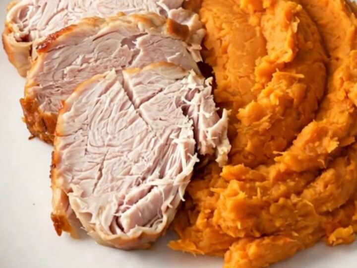 Slow cooker turkey breast and sweet potatoes served on a white plate.