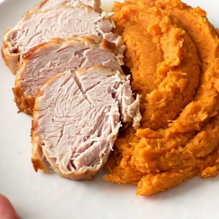 Slow cooker turkey breast and sweet potatoes served on a white plate.