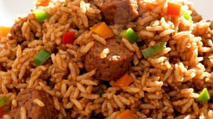 A steaming plate of slow cooker jambalaya with smoked sausage and peppers.