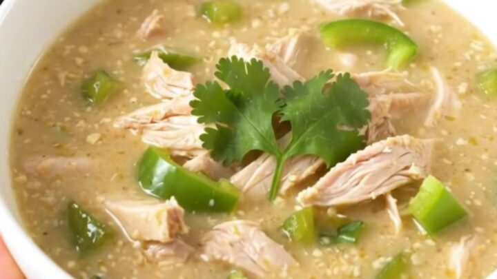A steaming bowl of creamy poblano chicken chowder garnished with fresh cilantro.