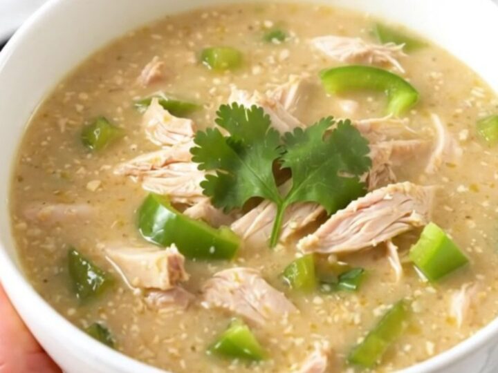 A steaming bowl of creamy poblano chicken chowder garnished with fresh cilantro.