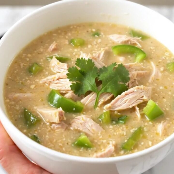A steaming bowl of creamy poblano chicken chowder garnished with fresh cilantro.