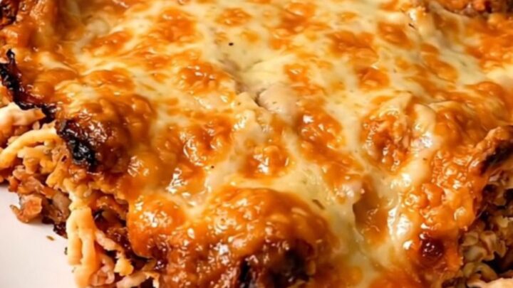 A slow cooker filled with a cooked beef and rice taco casserole on a kitchen counter.