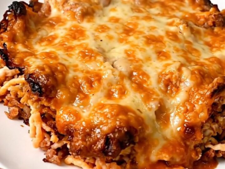 A slow cooker filled with a cooked beef and rice taco casserole on a kitchen counter.