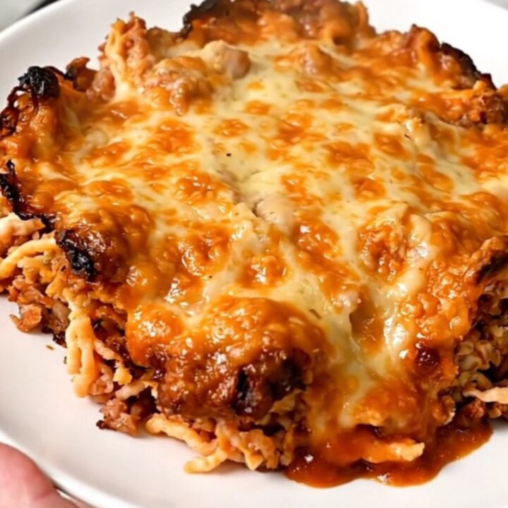 A slow cooker filled with a cooked beef and rice taco casserole on a kitchen counter.