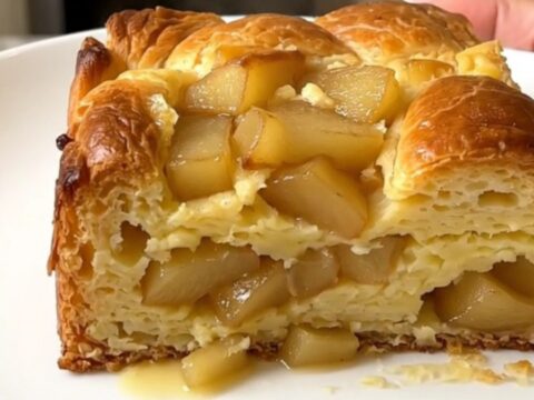 A warm, golden-brown apple cinnamon French toast casserole served on a white plate.