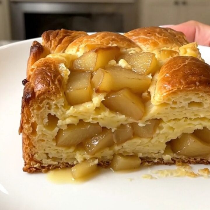 A warm, golden-brown apple cinnamon French toast casserole served on a white plate.