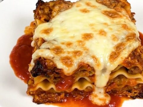 A steaming, hearty slow cooker lasagna with melted mozzarella cheese on top.