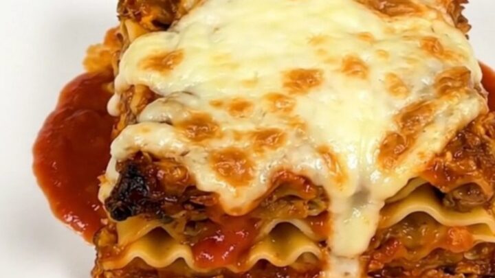 A steaming, hearty slow cooker lasagna with melted mozzarella cheese on top.