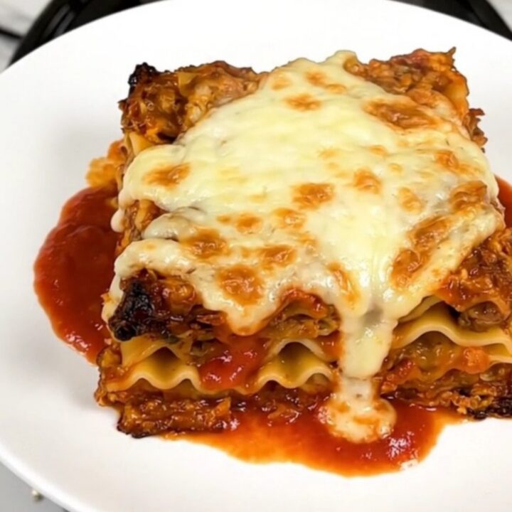 A steaming, hearty slow cooker lasagna with melted mozzarella cheese on top.