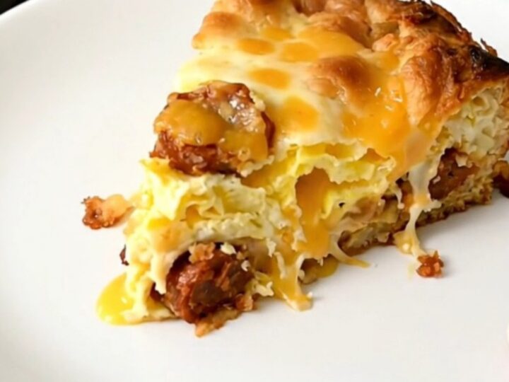 A steaming, golden-brown breakfast casserole with visible layers of chorizo, melted cheese, and hash browns in a slow cooker.