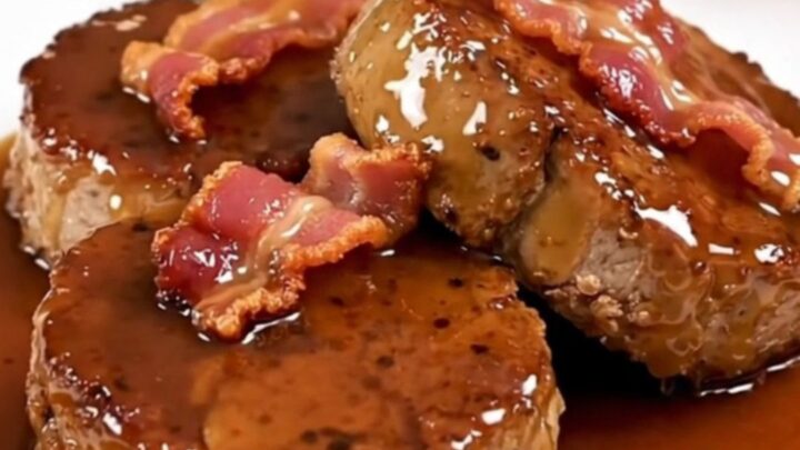 A close-up of glazed maple bacon pork tenderloin medallions on a white plate.