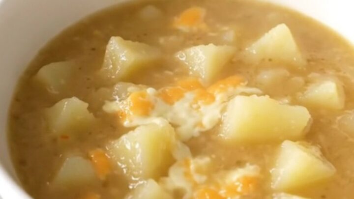 A close-up view of a bowl filled with creamy, steaming potato chowder.