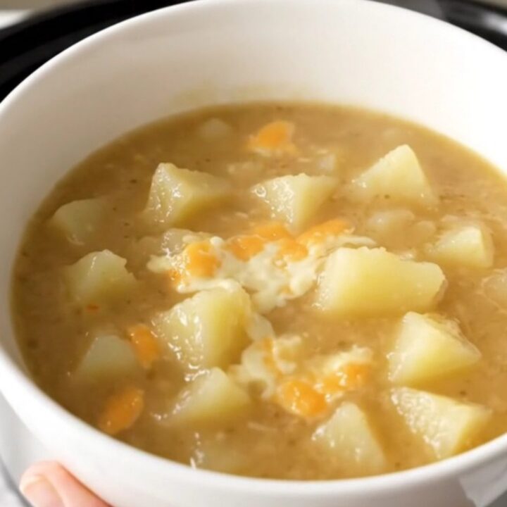 A close-up view of a bowl filled with creamy, steaming potato chowder.