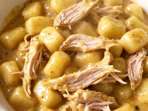 A warm, creamy bowl of ranch chicken and gnocchi served in a white dish.