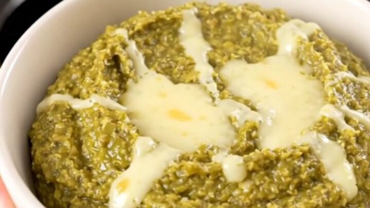 A warm, creamy Hatch green chile dip in a white bowl, steaming and glossy.