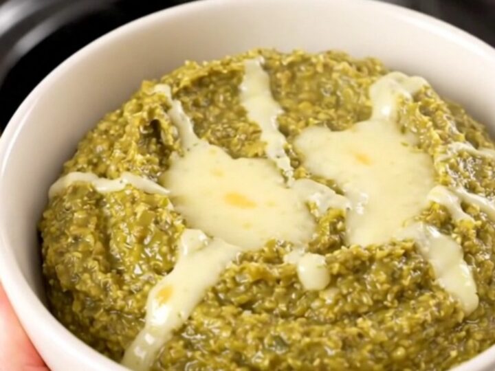 A warm, creamy Hatch green chile dip in a white bowl, steaming and glossy.