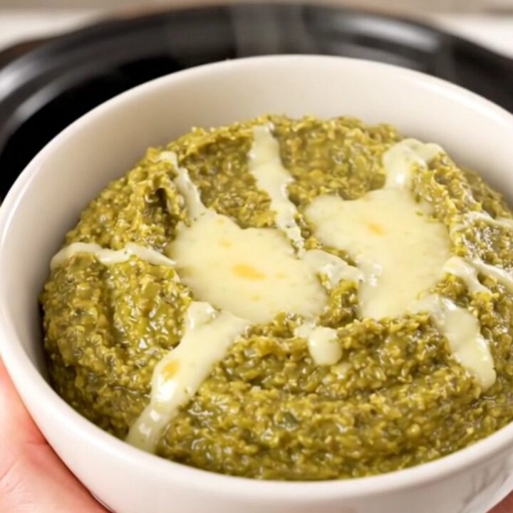 A warm, creamy Hatch green chile dip in a white bowl, steaming and glossy.