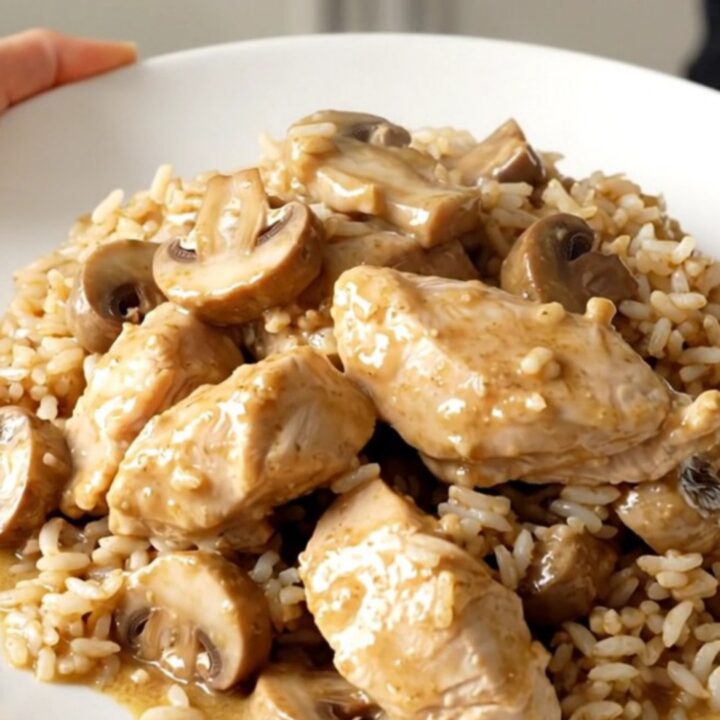 A plate of creamy Swiss mushroom chicken with tender breasts and savory mushrooms in a rich sauce.