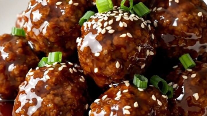 A top-down view of frozen turkey meatballs, pineapple, and teriyaki sauce in a slow cooker.