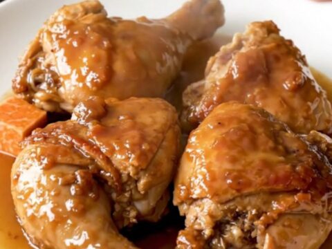 A close-up view of the finished maple black pepper chicken thighs and sweet potatoes in a slow cooker.