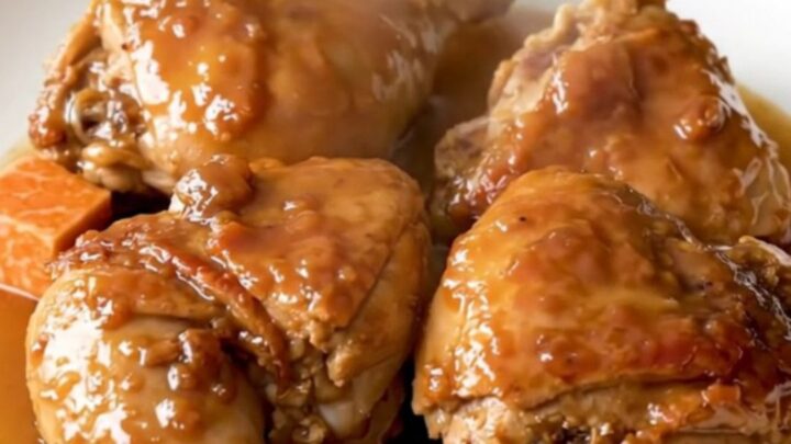 A close-up view of the finished maple black pepper chicken thighs and sweet potatoes in a slow cooker.