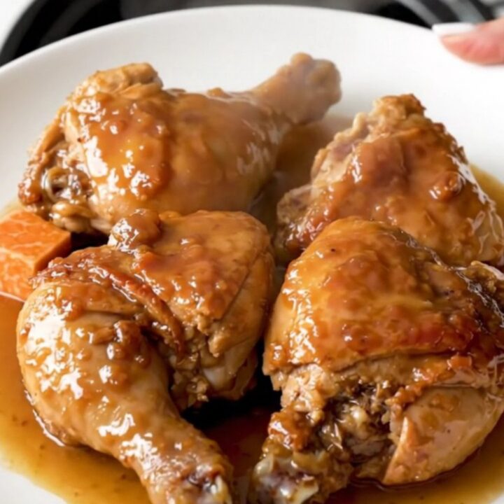 A close-up view of the finished maple black pepper chicken thighs and sweet potatoes in a slow cooker.