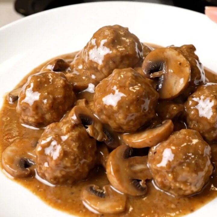 A top-down view of slow cooker turkey meatball stroganoff in a black ceramic insert.