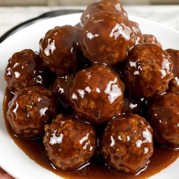 Slow cooker meatballs coated in a glossy spicy honey barbecue glaze.