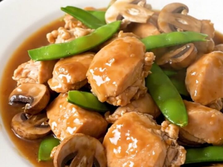 A top-down view of the finished Moo Goo Gai Pan in a slow cooker showing tender chicken and vegetables.