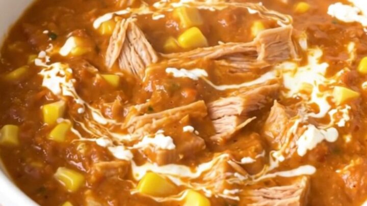 A bowl of creamy turkey and corn chili with a glossy, rich texture served in a white bowl.