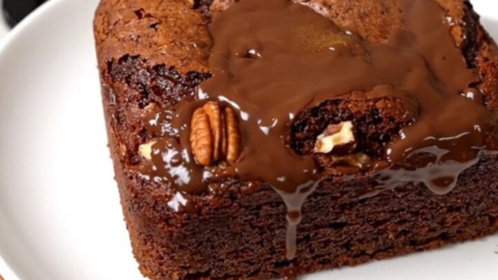 A rich German chocolate dump cake in a slow cooker topped with coconut and pecans.