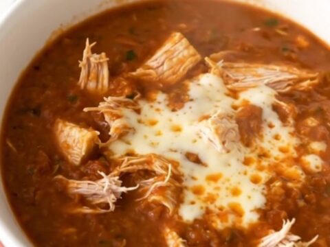 A bowl of hearty white bean chicken taco chili topped with melted pepper jack cheese.