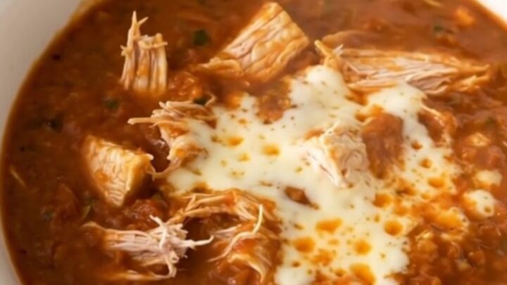A bowl of hearty white bean chicken taco chili topped with melted pepper jack cheese.