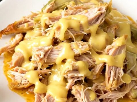 Slow cooker filled with creamy chicken and artichoke hearts.