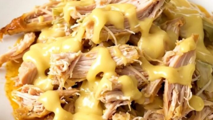 Slow cooker filled with creamy chicken and artichoke hearts.