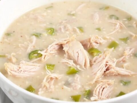 A steaming bowl of creamy green chile chicken chowder garnished with a hint of fresh cilantro.