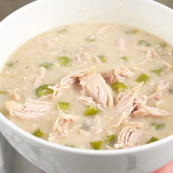 A steaming bowl of creamy green chile chicken chowder garnished with a hint of fresh cilantro.