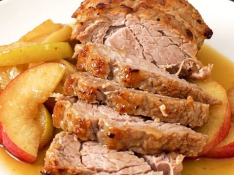 A slow cooker filled with pork tenderloin and sliced apples simmered in a spiced cider glaze.
