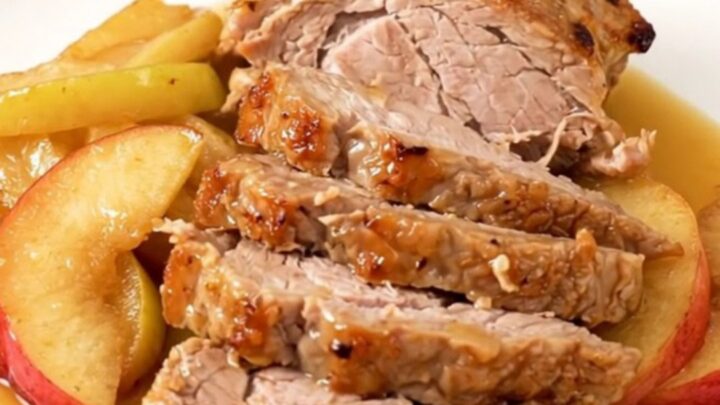A slow cooker filled with pork tenderloin and sliced apples simmered in a spiced cider glaze.