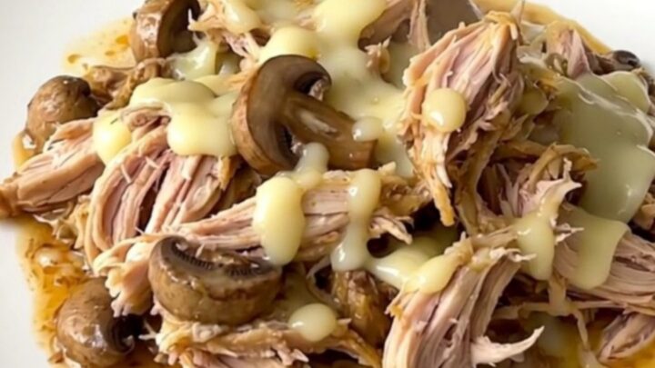 Creamy mushroom gruyere chicken served in a white bowl with a rich, glossy sauce.