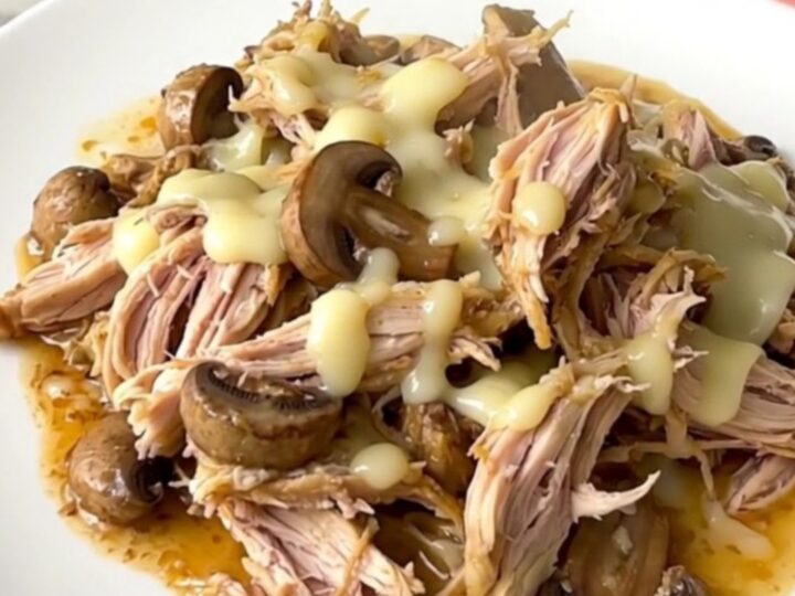 Creamy mushroom gruyere chicken served in a white bowl with a rich, glossy sauce.