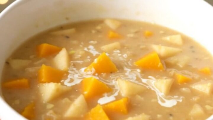 A bowl of creamy butternut squash and apple chowder with a smooth, orange texture.
